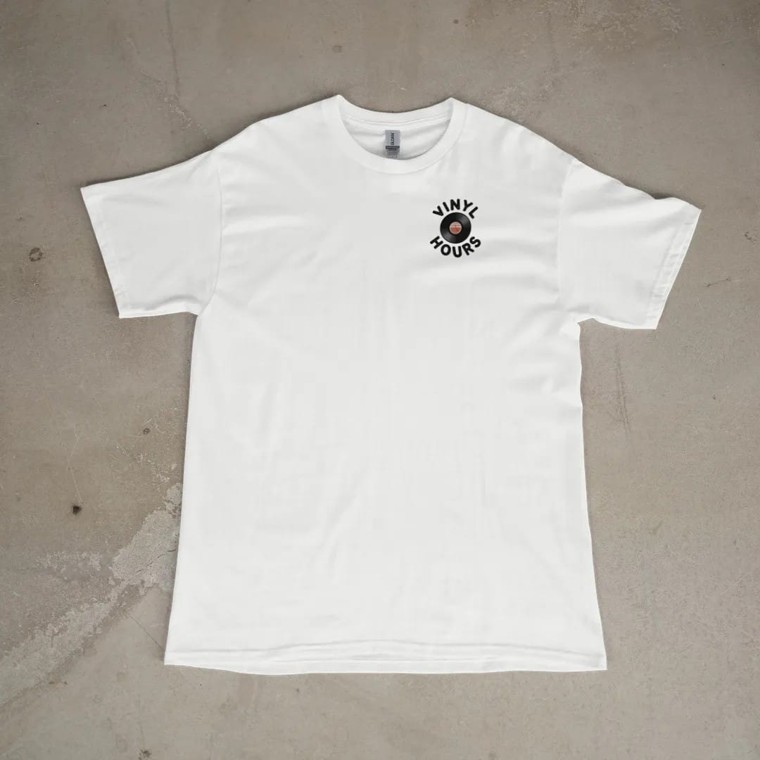 Front of a White tee laid flat, with the small Vinyl Hours logo on the left chest.