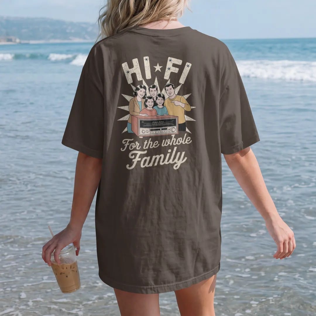 Woman on the beach in a Espresso tee, back view: a 1950s-ad family gathered around a wooden console stereo, with "HI-FI" and "FOR THE WHOLE FAMILY" in chunky 70s lettering and brush script, printed in faded, cracked cream, mustard, burnt orange and…