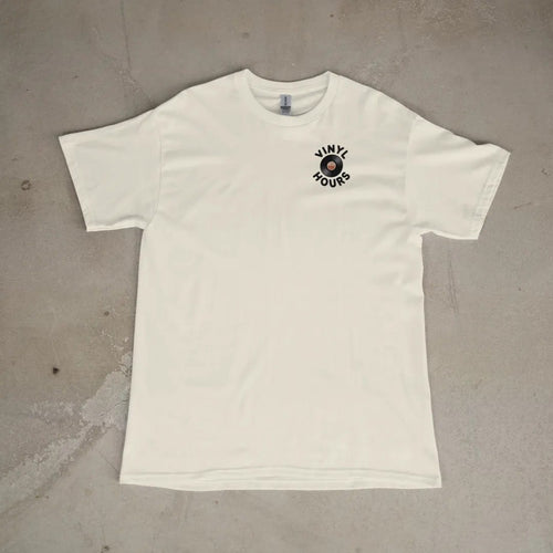 Front of a Ivory tee laid flat, with the small Vinyl Hours logo on the left chest.