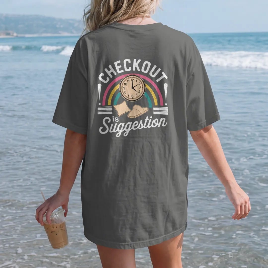 Woman on the beach in a Pepper tee, back view: a starburst wall clock with a pillow and slipper, with "CHECKOUT" and "IS A SUGGESTION" in chunky 70s lettering and brush script, printed in faded, cracked cream, mustard and turquoise with a neon pink…