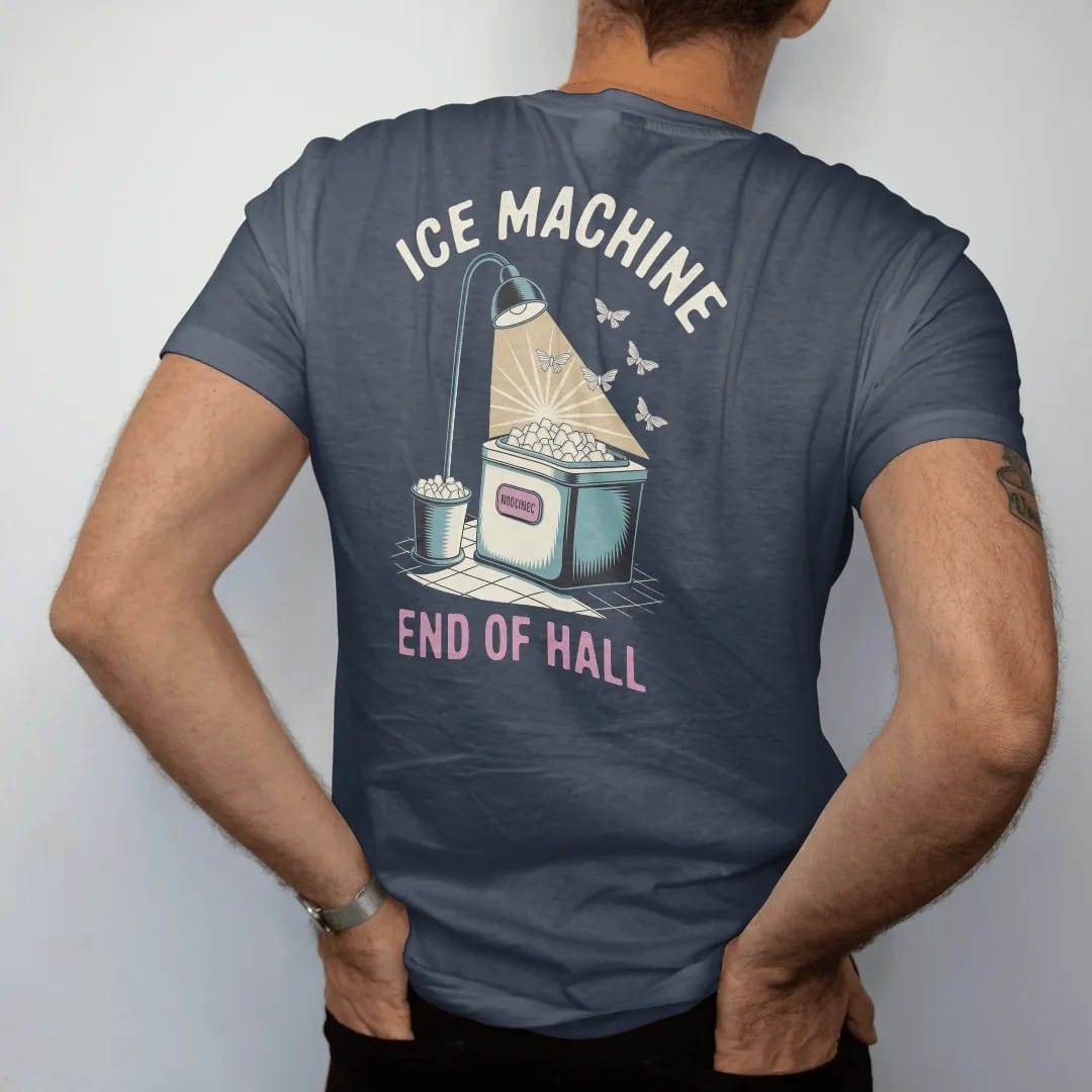 Man wearing a Midnight tee, seen from the back: a glowing motel ice machine with an overflowing ice bucket, with "ICE MACHINE" and "END OF HALL" in chunky 70s lettering and small 70s caps, printed in faded, cracked cream, mustard and turquoise with…