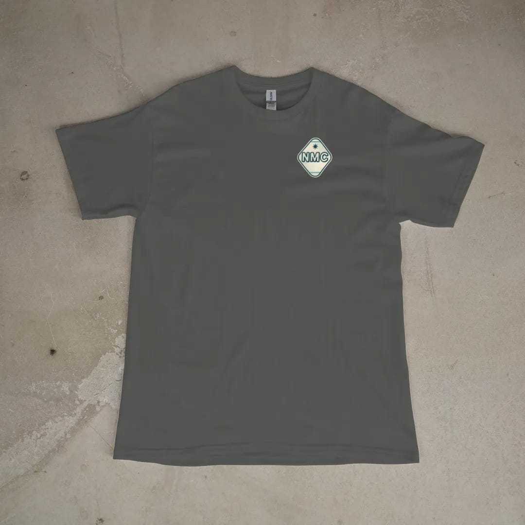Front of a Pepper tee laid flat, with the small Neon Motor Court logo on the left chest.
