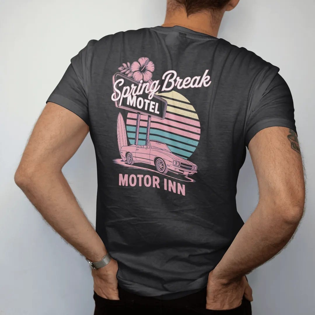 Man wearing a Black tee, seen from the back: a beach motel sign with hibiscus, a surfboard and a convertible, with "SPRING BREAK" and "MOTOR INN" in neon-tube script and small 70s caps, printed in faded, cracked navy, rust red and dusty teal with a…