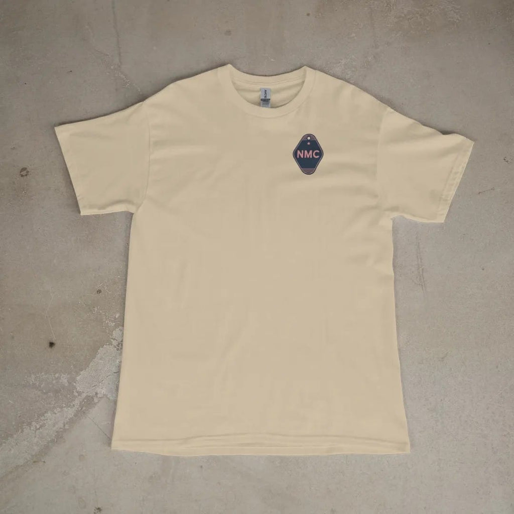 Front of a Sandstone tee laid flat, with the small Neon Motor Court logo on the left chest.