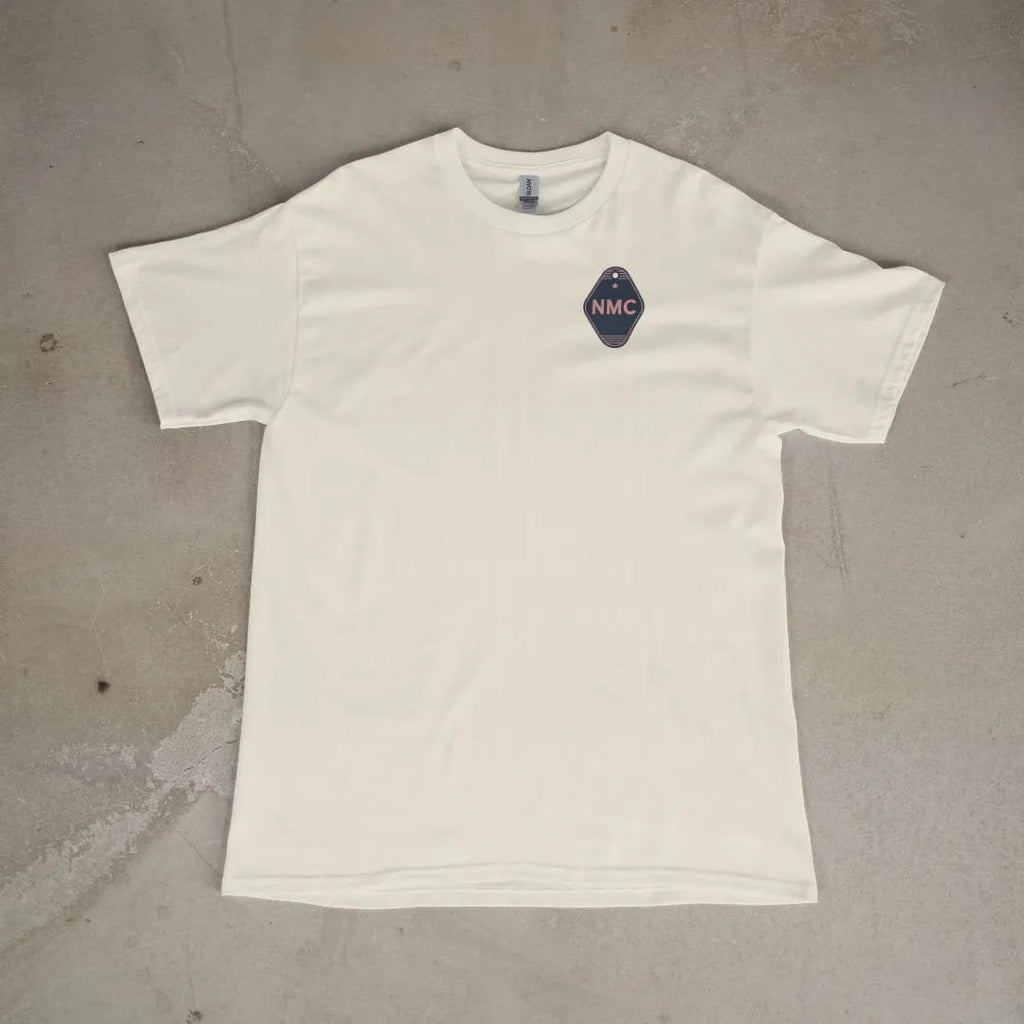Front of a Ivory tee laid flat, with the small Neon Motor Court logo on the left chest.