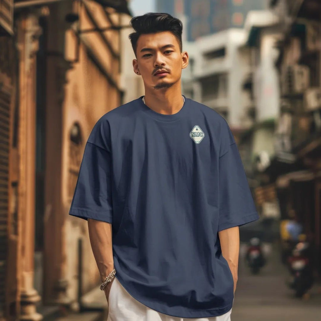 Man in a Navy tee on a city street, with the small Neon Motor Court logo on the left chest.
