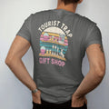 Man wearing a Pepper tee, seen from the back: a roadside gift shop shelf with snow globes and a jackalope figurine, with "TOURIST TRAP" and "GIFT SHOP" in chunky 70s lettering and small 70s caps, printed in faded, cracked cream, mustard and…