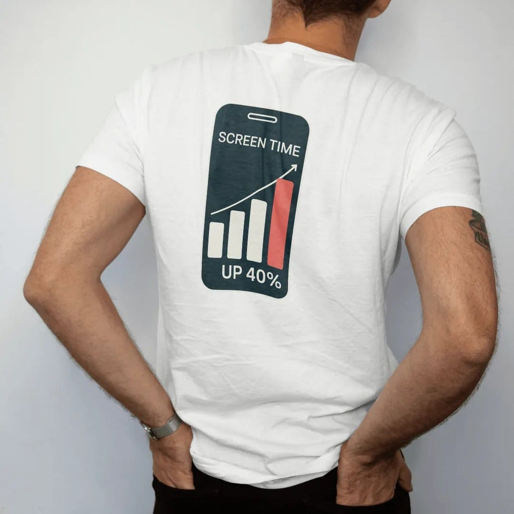 Man wearing a White tee, seen from the back: minimal single-line drawing of a phone outline with a simple rising bar graph on the screen, with "SCREEN TIME / UP 40%" in small spaced-out caps, printed in bone white with a low-battery red accent on…