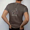 Man wearing a Espresso tee, seen from the back: minimal single-line drawing of a chat bubble outline with two small checkmarks under a thin crescent moon, with "READ 2:14 AM" in small spaced-out caps, printed in bone white with a low-battery red…
