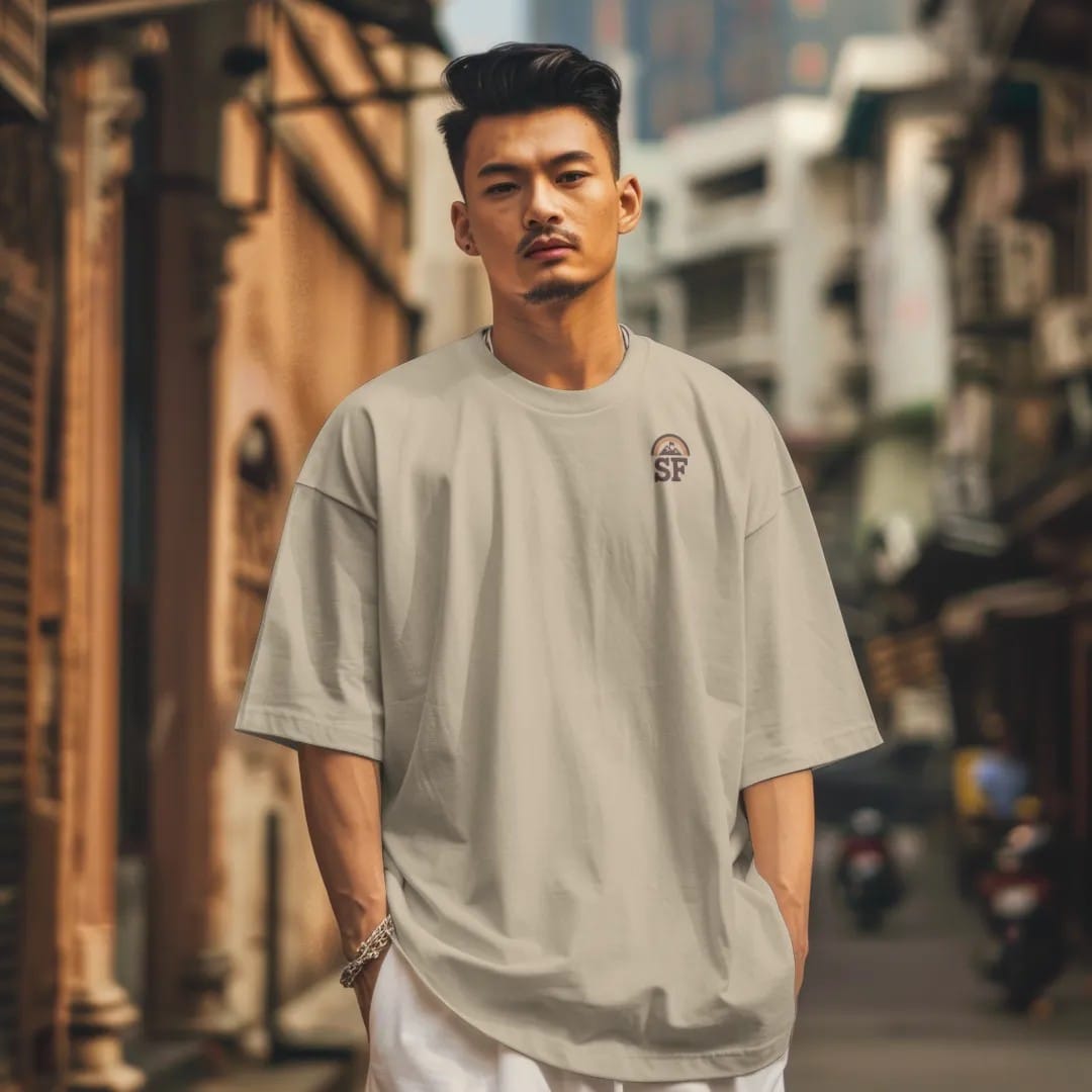 Man in a Sandstone tee on a city street, with the small Summit Fever logo on the left chest.