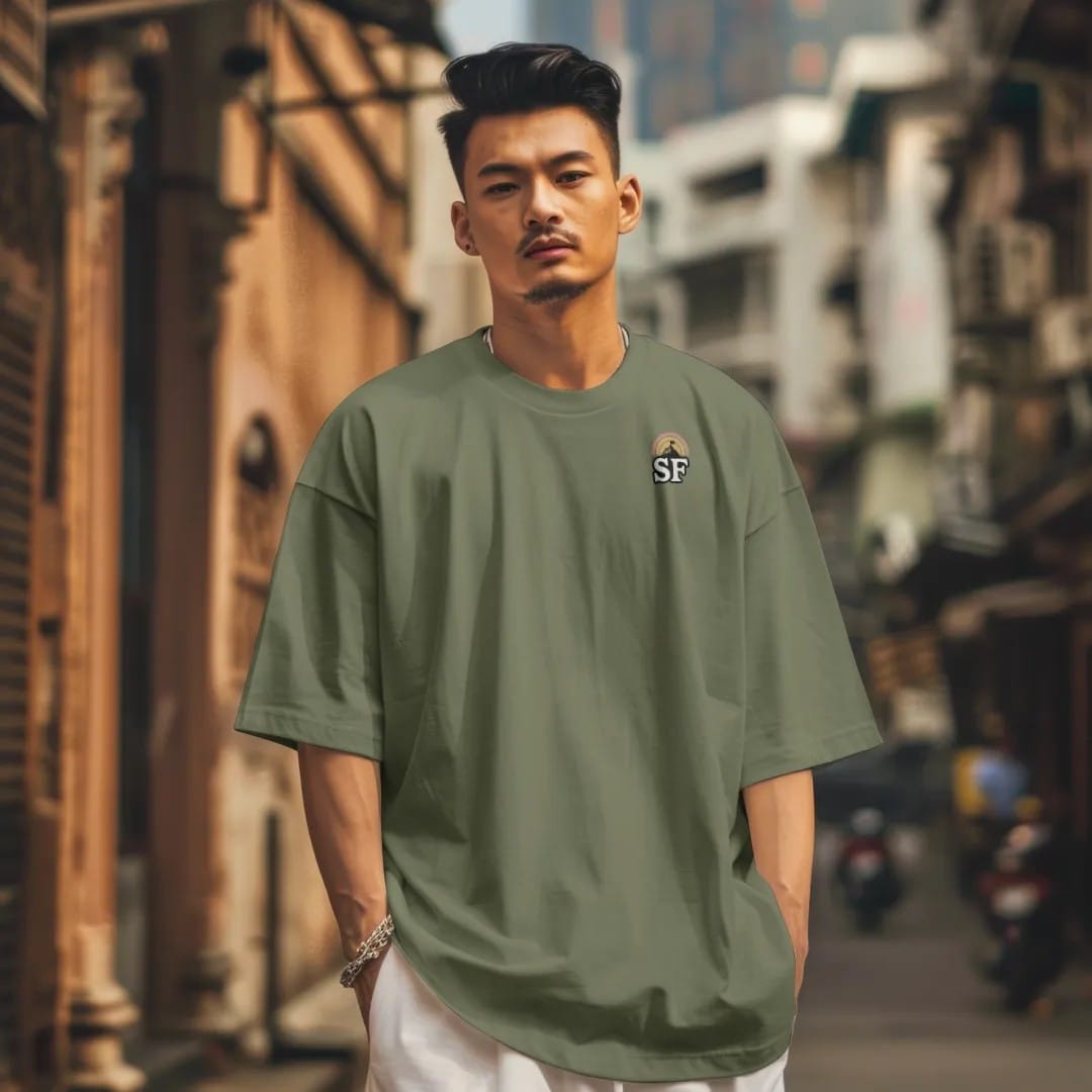 Man in a Moss tee on a city street, with the small Summit Fever logo on the left chest.