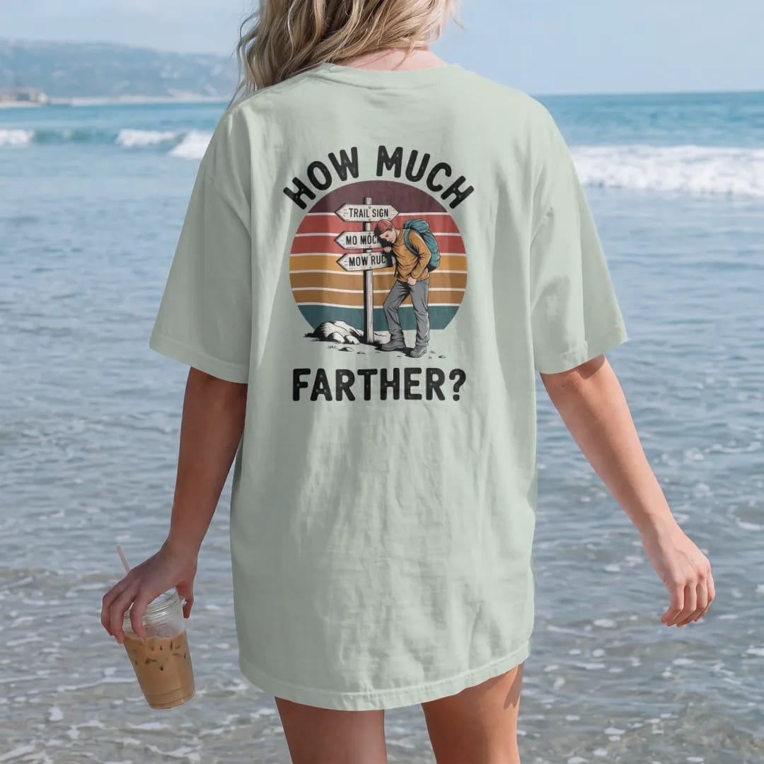 Woman on the beach in a Bay tee, back view: a trail sign with mileage numbers crossed out and rewritten higher, a tired hiker leaning on it, faded 70s souvenir style, lettered "HOW MUCH / FARTHER?" in chunky rounded 70s letters with a drop shadow,…