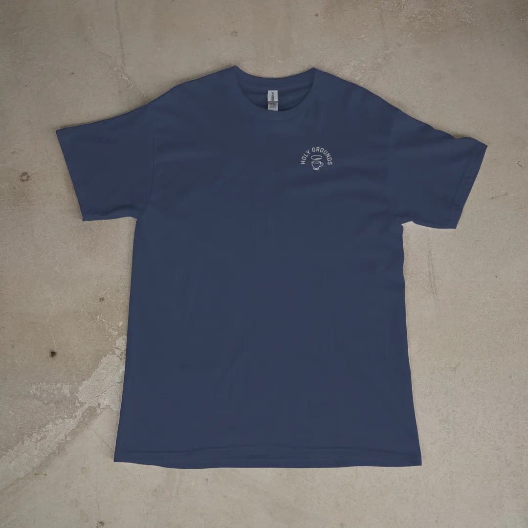 Front of a Navy tee laid flat, with the small Holy Grounds logo on the left chest.