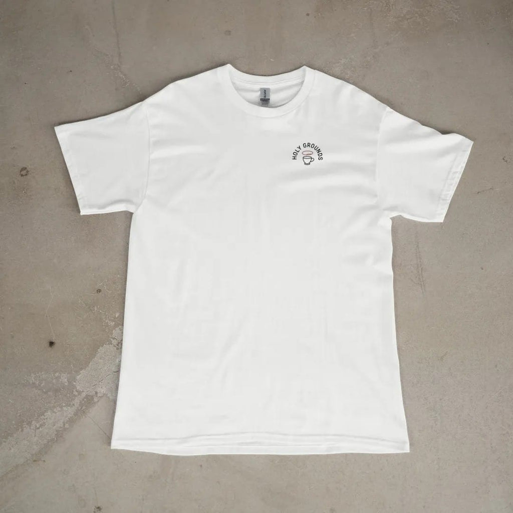 Front of a White tee laid flat, with the small Holy Grounds logo on the left chest.