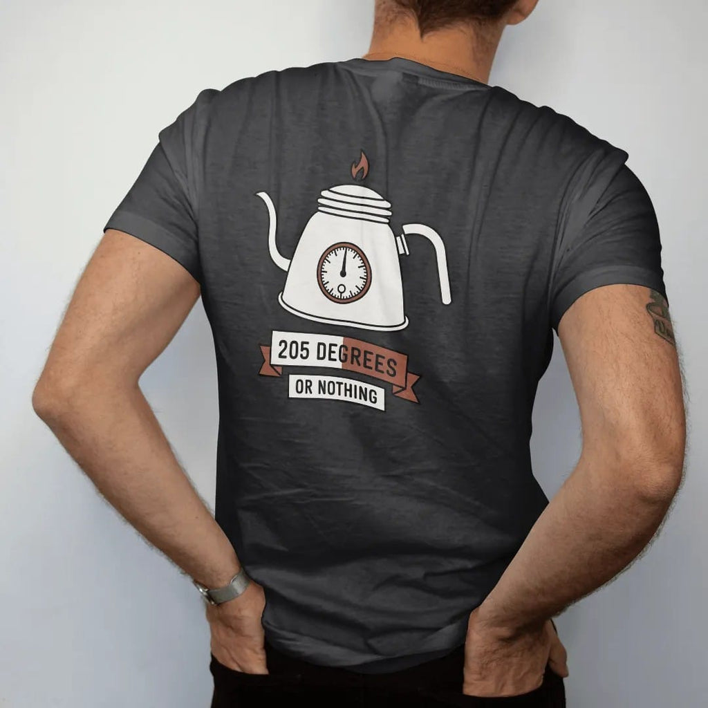 Man wearing a Black tee, seen from the back: a gooseneck kettle with a dial thermometer on its lid, 205 Degrees in clean numerals and Or Nothing on a banner, drawn in a single fine crema-cream line with one burnt copper accent.