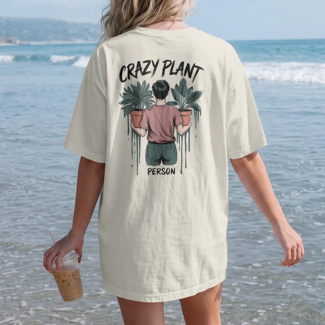 Woman on the beach in a Ivory tee, back view: a figure holding an armful of potted plants, "CRAZY PLANT" in loose brush script above and "PERSON" small below, painted in loose watercolor and ink with soft deep green, terracotta, soil brown and moss…