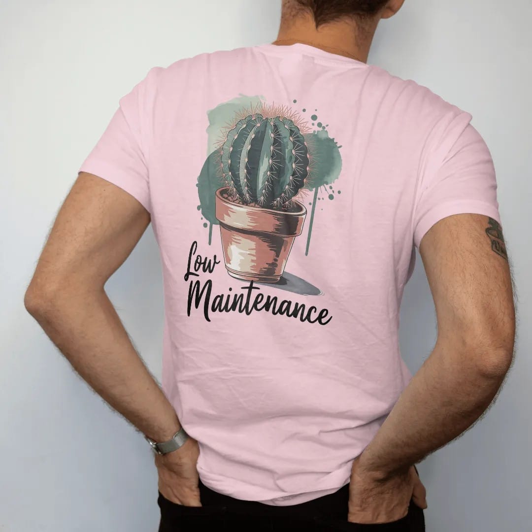 Man wearing a Blossom tee, seen from the back: a single round cactus in a small terracotta pot, small brush-written caps "LOW MAINTENANCE" beneath, painted in loose watercolor and ink with soft deep green, terracotta, soil brown and moss washes.