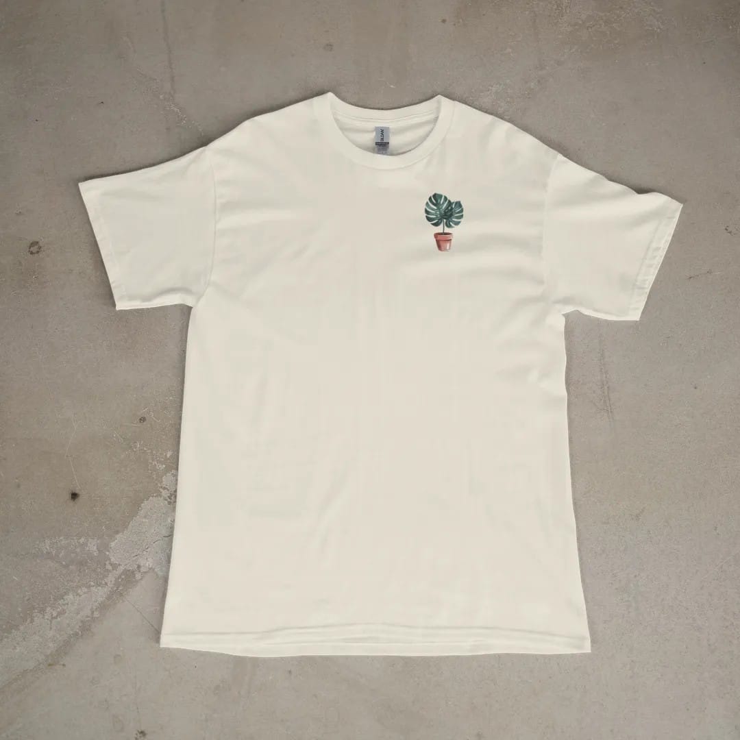 Front of a Ivory tee laid flat, with the small Plant Parent Co. logo on the left chest.