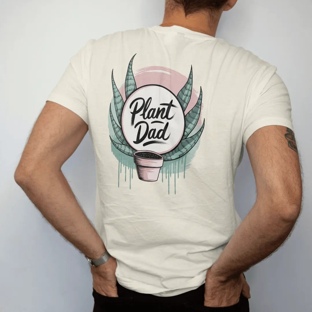 Man wearing a Ivory tee, seen from the back: a neat round badge framed by two snake-plant leaves with a small pot in the center, "PLANT DAD" in loose brush script across the bottom, painted in loose watercolor and ink with soft mint, clay pink,…