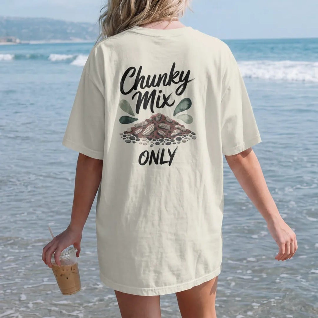 Woman on the beach in a Ivory tee, back view: a small pile of chunky potting mix with bark, perlite and pebbles, "CHUNKY MIX" in loose brush script above and "ONLY" small below, painted in loose watercolor and ink with soft deep green, terracotta,…