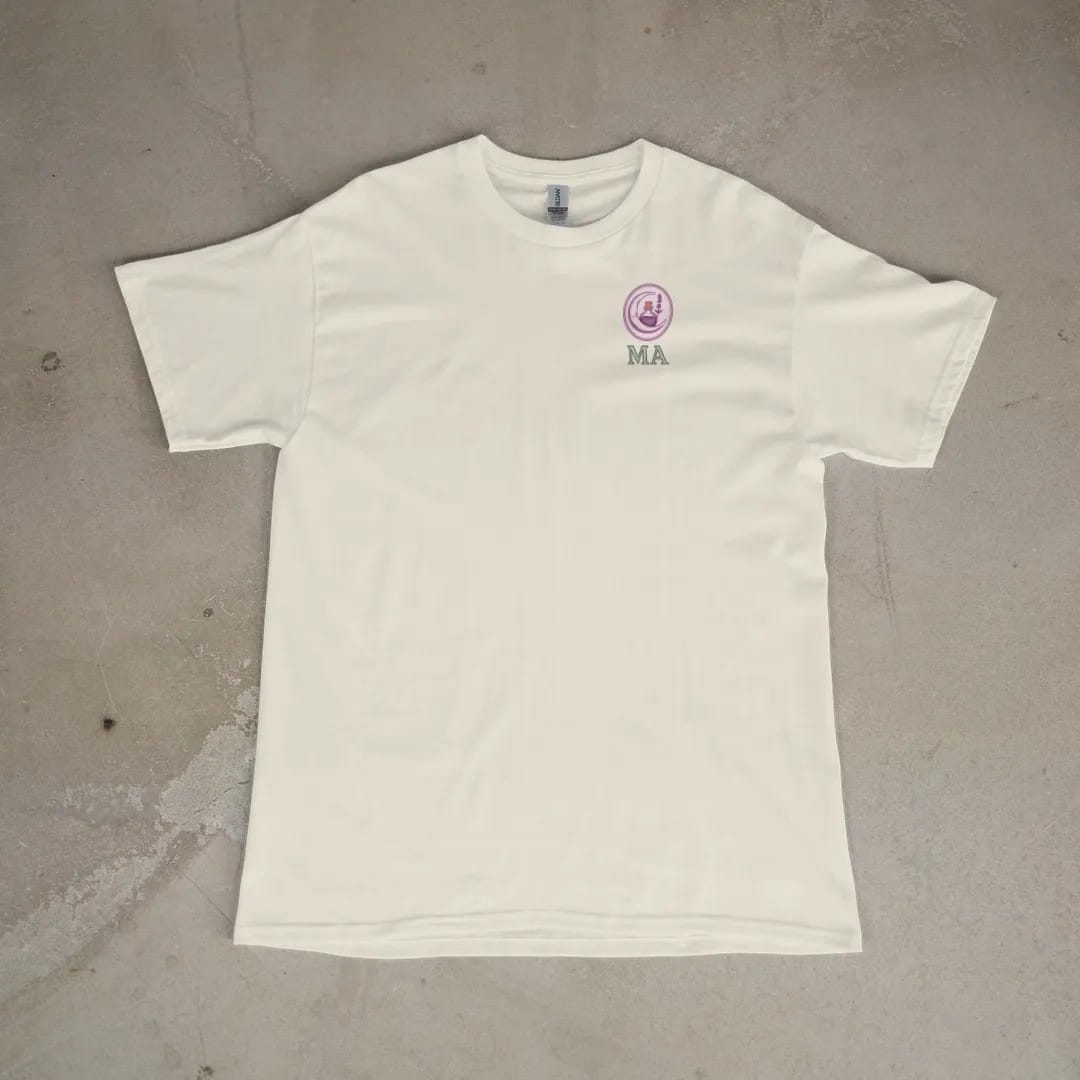 Front of a Ivory tee laid flat, with the small Midnight Apothecary logo on the left chest.