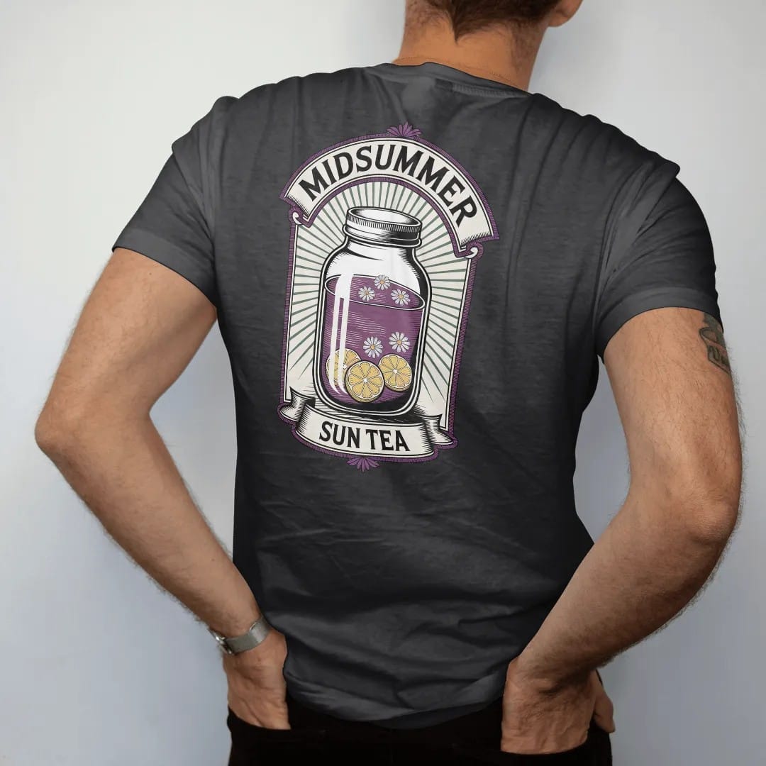 Man wearing a Black tee, seen from the back: back print: A big glass jar of sun tea with floating chamomile and lemon slices, radiating sun rays, arched "MIDSUMMER" above and small banner "SUN TEA" below, antique apothecary-label engraving, fine…