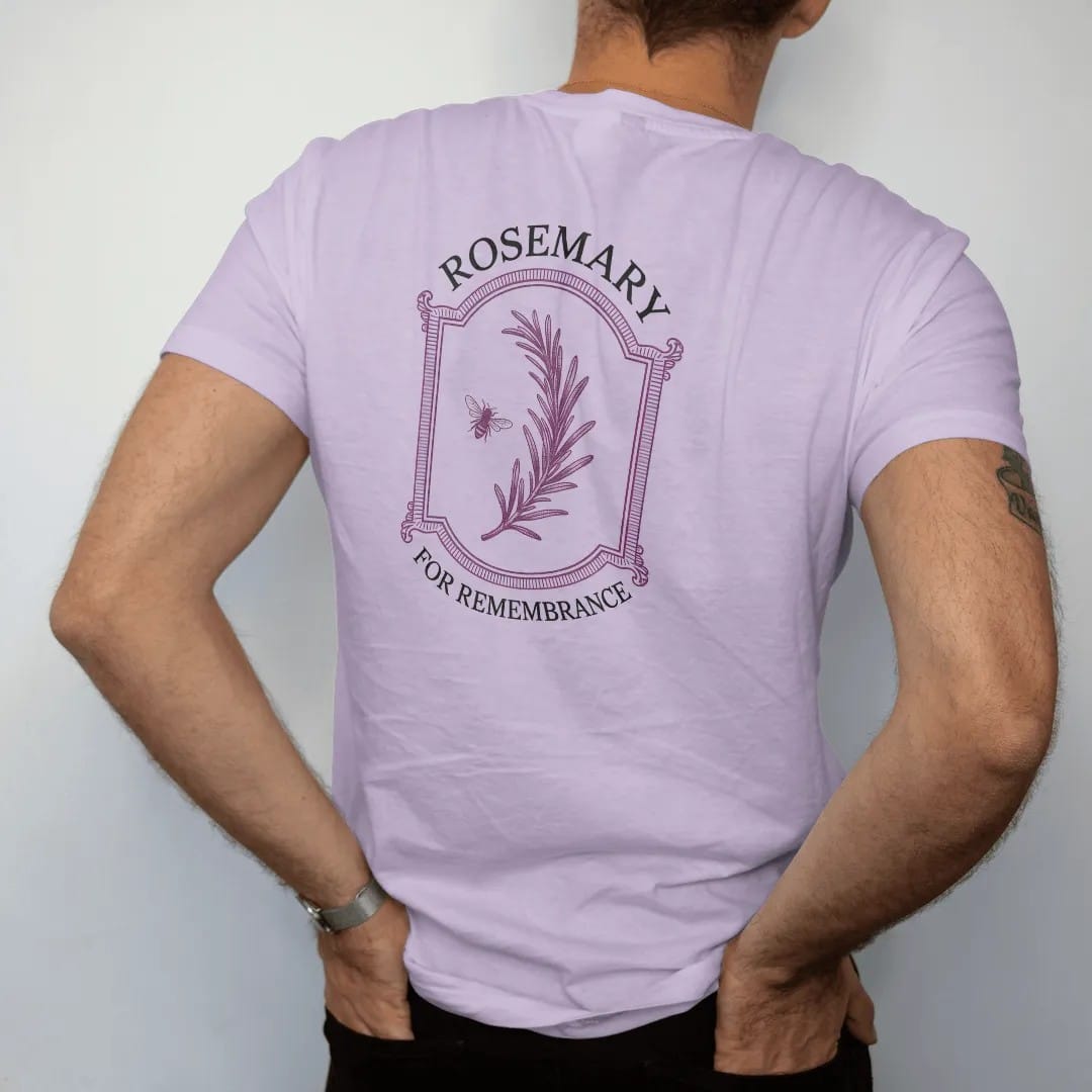 Man wearing a Orchid tee, seen from the back: back print: A single long sprig of rosemary in fine engraving with a tiny bee, "ROSEMARY" above and "FOR REMEMBRANCE" in small caps below, antique apothecary-label engraving, fine crosshatching, ornate…