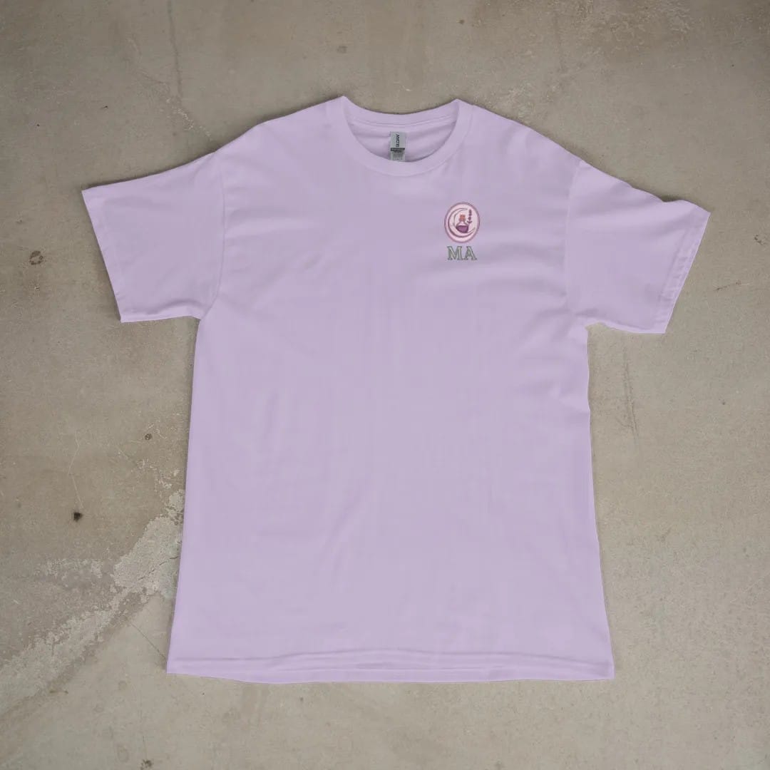 Front of a Orchid tee laid flat, with the small Midnight Apothecary logo on the left chest.