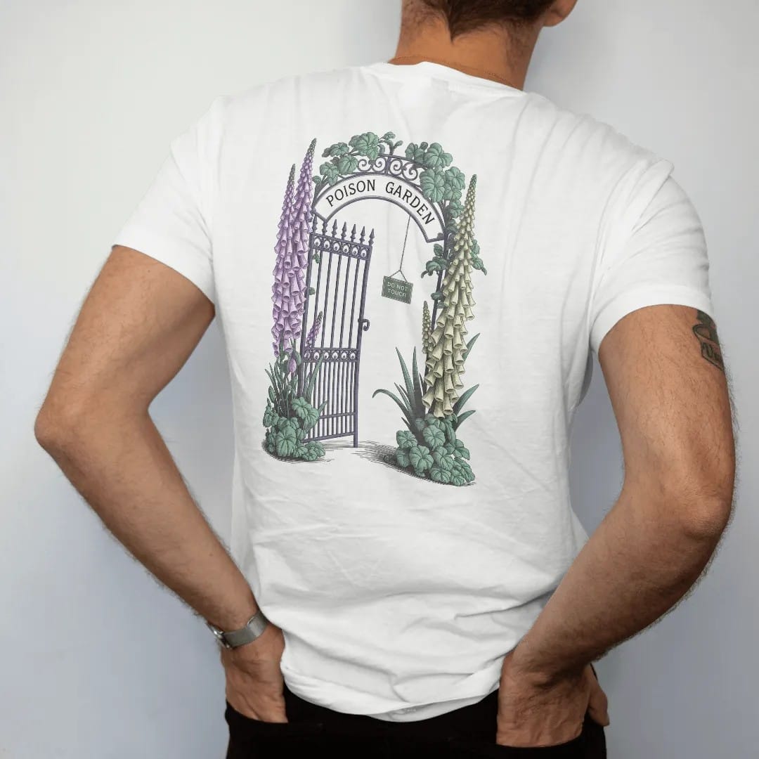 Man wearing a White tee, seen from the back: back print: an iron garden gate wrapped in foxglove, belladonna and hemlock blossoms, "POISON GARDEN" arched over the gate and "DO NOT TOUCH" on a tiny hanging sign, detailed vintage etching, fine…