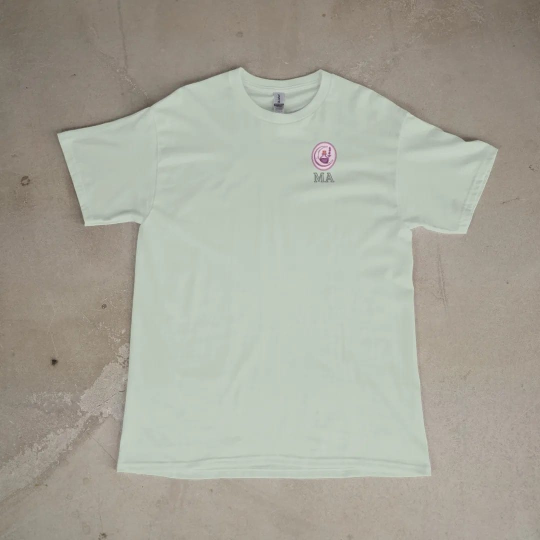 Front of a Bay tee laid flat, with the small Midnight Apothecary logo on the left chest.