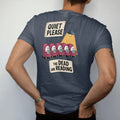Man wearing a Midnight tee, seen from the back: a library placard reading Quiet Please over a row of small ghosts reading in armchairs, with The Dead Are Reading below, in pulp halftone cream, red, yellow and blue.