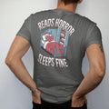 Man wearing a Pepper tee, seen from the back: a skeleton asleep with a horror book over its face while eyes peek from under the bed and closet, with Reads Horror above and Sleeps Fine below, in pulp halftone cream, red, yellow and blue.