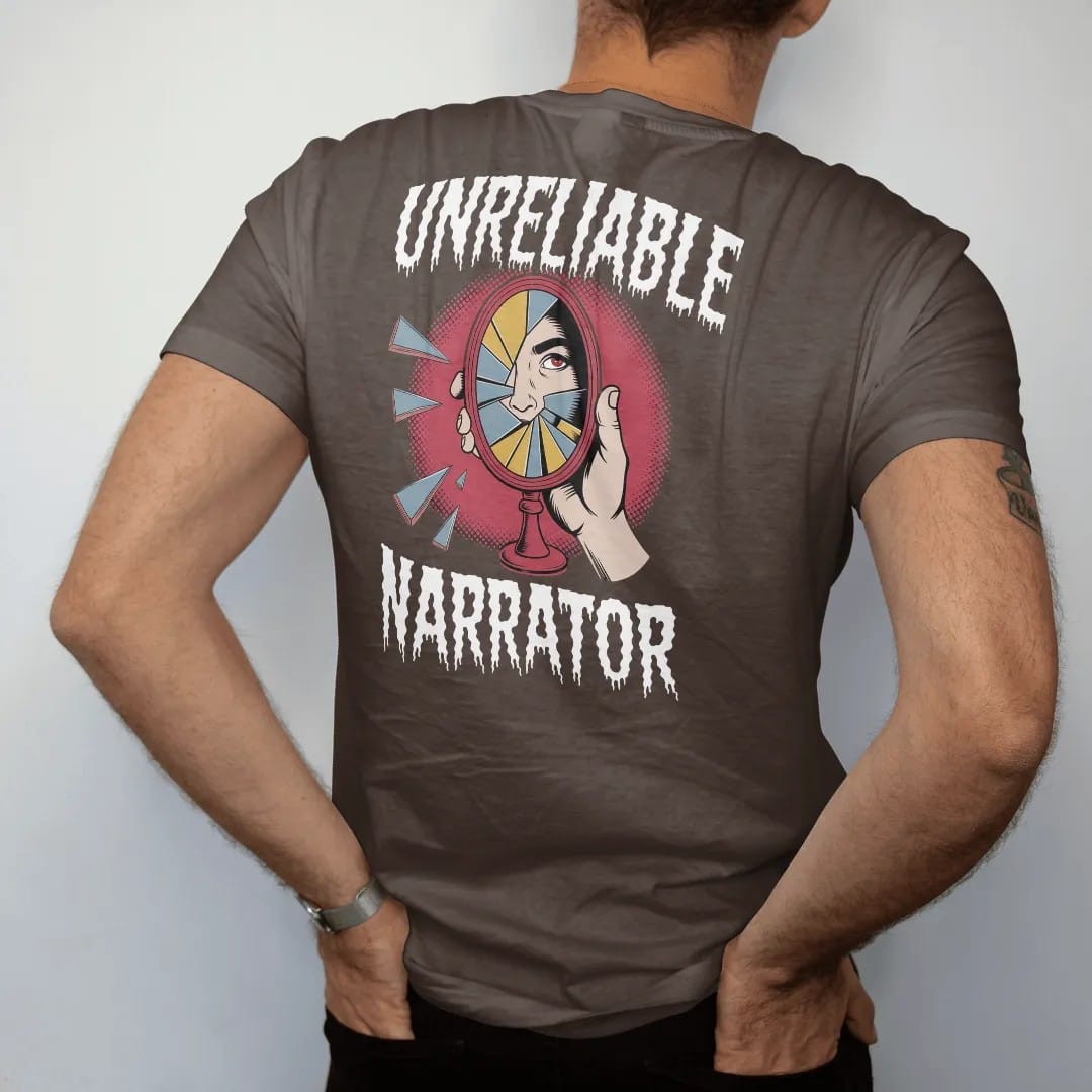 Man wearing a Espresso tee, seen from the back: a cracked hand mirror reflecting a different face, Unreliable above and Narrator below in shattered type, in pulp halftone cream, red, yellow and blue.