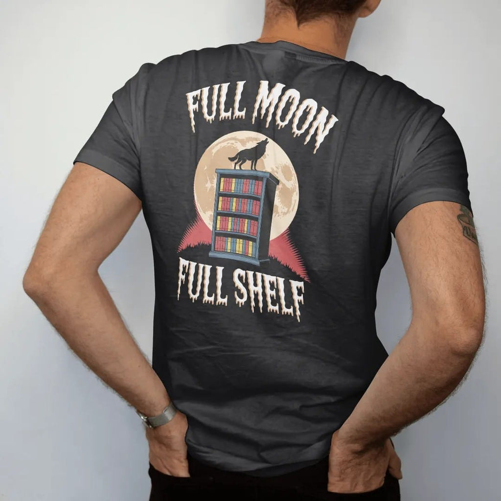 Man wearing a Black tee, seen from the back: a full moon behind a bookshelf on a hill with a wolf howling on top, with Full Moon above and Full Shelf below, in pulp halftone cream, red, yellow and blue.