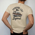 Man wearing a Sandstone tee, seen from the back: a classic wood-paneled station wagon with the tailgate down, a grill and a pennant flag, with "PARKING LOT" and "LEGEND" in chunky 1970s swash script, printed in faded stadium green, washed brick…