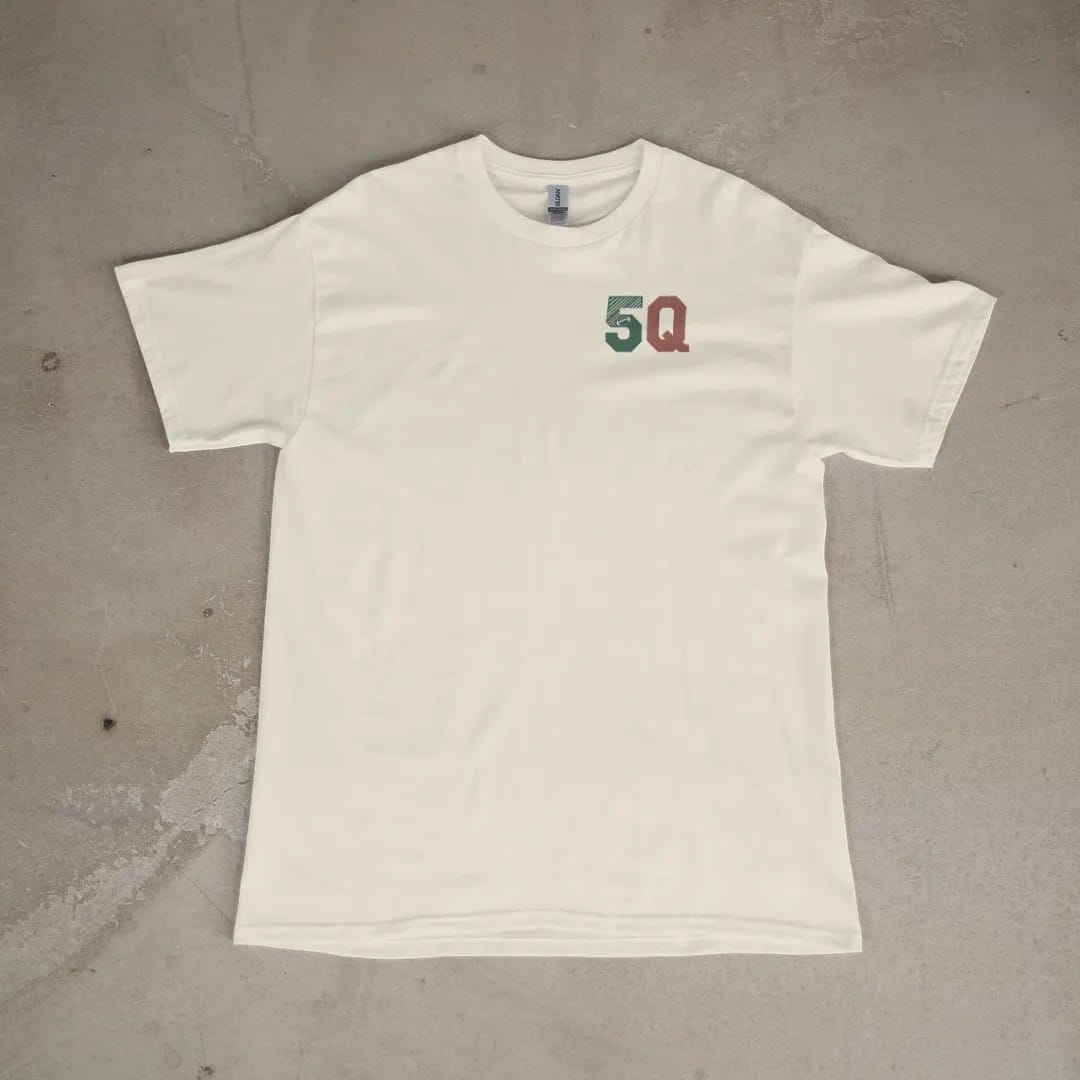 Front of a Ivory tee laid flat, with the small Fifth Quarter Tailgate logo on the left chest.