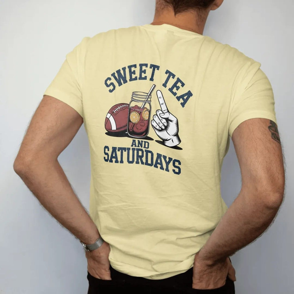 Man wearing a Butter tee, seen from the back: a mason jar of iced tea with lemon next to a football and a paper hand fan, with "SWEET TEA" and "AND SATURDAYS" in chunky 1970s swash script, printed in faded stadium green, washed brick red, faded…