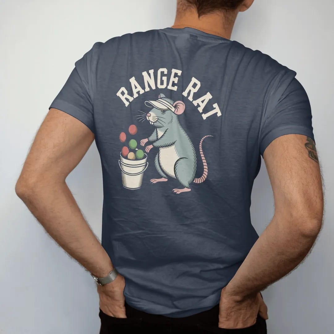 Man wearing a Midnight tee, seen from the back: a cheerful rat in a visor hitting balls from a bucket at a driving range, with "RANGE RAT" in loopy 1970s script, printed in faded clubhouse cream, sage grass green, washed flag red and sand gold with…