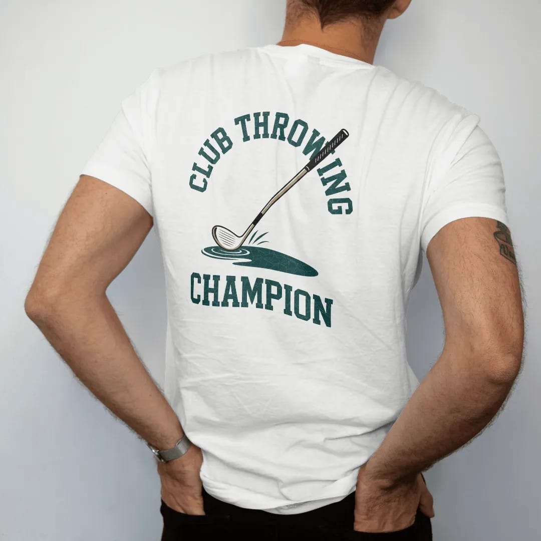 Man wearing a White tee, seen from the back: a golf club tumbling end over end through the air toward a pond, with "CLUB THROWING" and "CHAMPION" in chunky faded collegiate block letters, printed in faded clubhouse cream, sage grass green, washed…