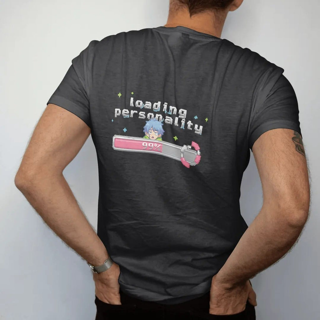 Man wearing a Black tee, seen from the back: a nearly full pixel loading bar reading 99% with a sleepy anime-style kid peeking over it, under loading personality in pink, lime and blue pixel letters.