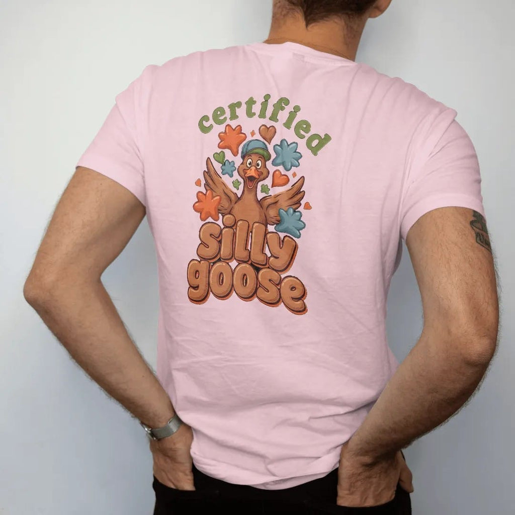 Man wearing a Blossom tee, seen from the back: a goofy goose in a backwards cap surrounded by puffy stars and hearts, with certified in an arched stamp and silly goose in fat bubble letters, in brown, rust, moss and denim.