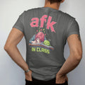 Man wearing a Pepper tee, seen from the back: an anime-style teen asleep on a desk with Blip the slime napping on a textbook and pixel Zs floating up, under afk in big pixel letters with in class below, in pink, lime, blue and silver.