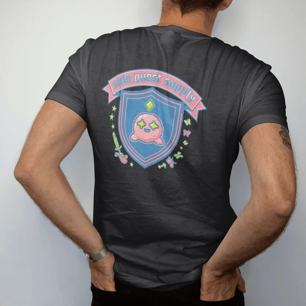 Man wearing a Black tee, seen from the back: a varsity crest with Blip the pixel slime under a quest marker, a crossed skateboard and pixel sword, with side quest supply in an arched varsity banner, in pink, lime, yellow and blue.