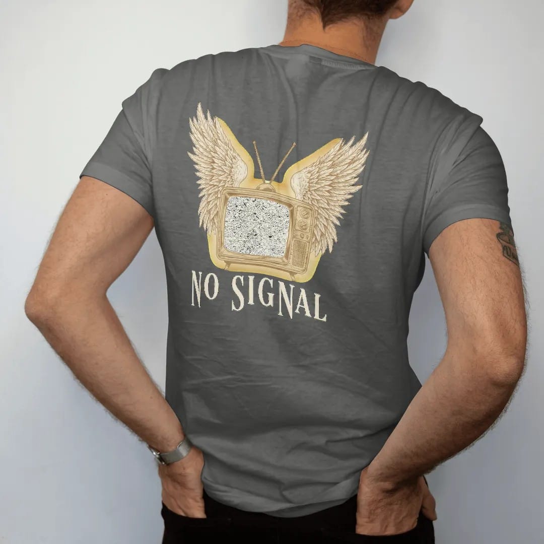 Man wearing a Pepper tee, seen from the back: a vintage cabinet television with angel wings and a screen full of static, above No Signal in widely spaced fashion serif capitals, in bone cream, chrome silver and antique gold.