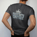 Man wearing a Black tee, seen from the back: Frostbite Couture in tall frosted-chrome blackletter dripping icicles under a crown of ice crystals with rhinestone snow sparkles, in chrome silver, bone cream and ice blue.
