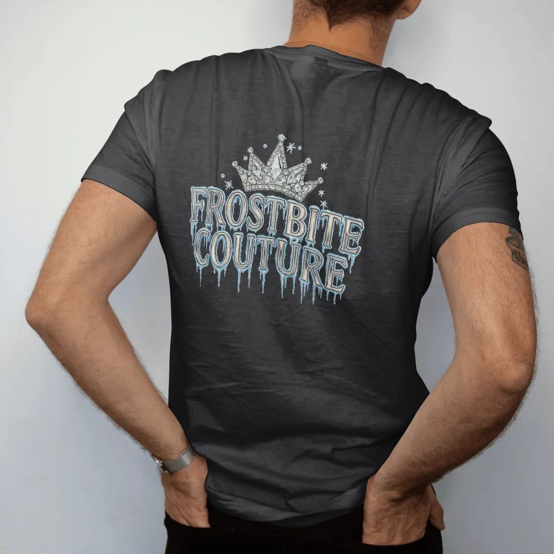 Man wearing a Black tee, seen from the back: Frostbite Couture in tall frosted-chrome blackletter dripping icicles under a crown of ice crystals with rhinestone snow sparkles, in chrome silver, bone cream and ice blue.