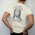 Man wearing a Ivory tee, seen from the back: a classical marble angel bust with a barbed-wire crown, Fits Over arched above in serif and Everything spaced below.