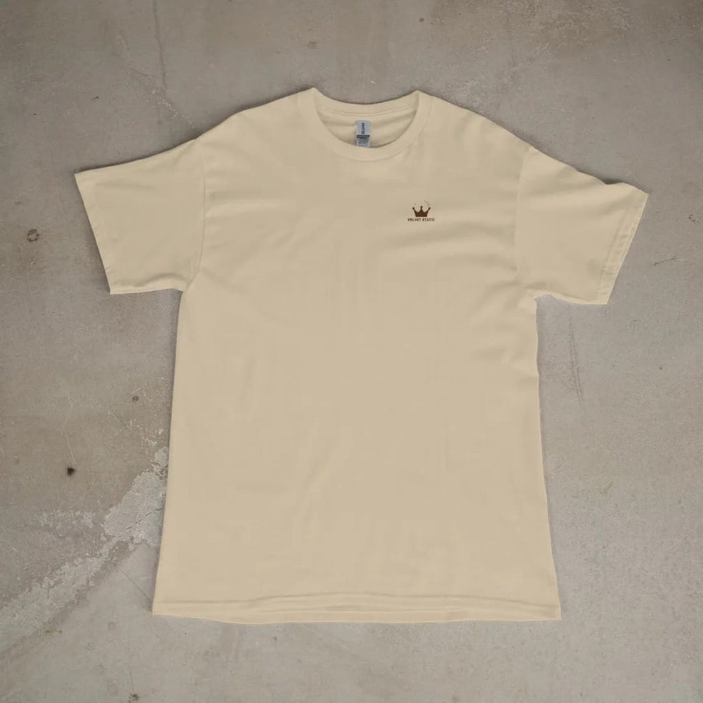 Front of a Sandstone tee laid flat, with the small Velvet Static logo on the left chest.