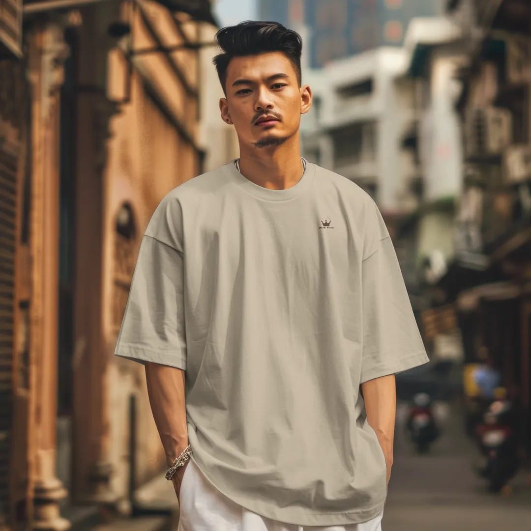 Man in a Sandstone tee on a city street, with the small Velvet Static logo on the left chest.