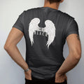 Man wearing a Black tee, seen from the back: a huge pair of spread engraved angel wings with Angels Wear in gothic blackletter between them and Black in spaced serif capitals beneath, in single-ink bone cream.
